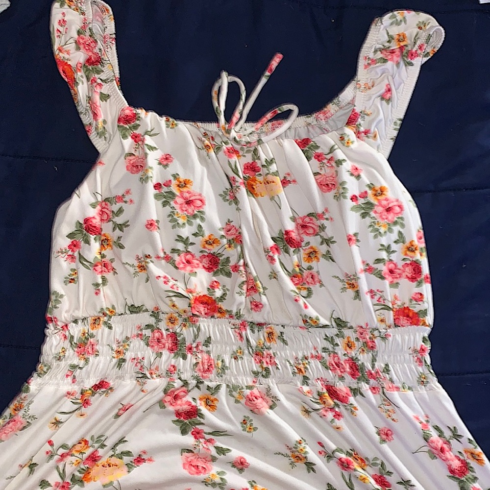 A pretty white floral print dress w/ breast padded top. Low cut dress.